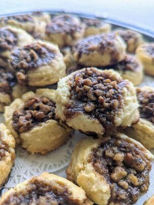 A close-up of a plate of cookies topped with a crumbly brown mixture.